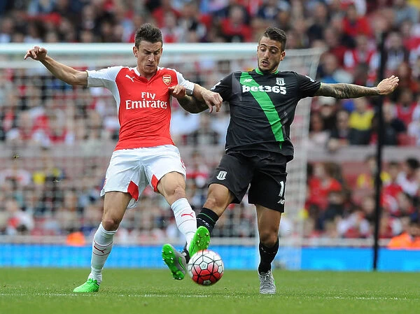 Intense Battle: Koscielny Tackles Joselu in Arsenal vs Stoke City (2015-16)