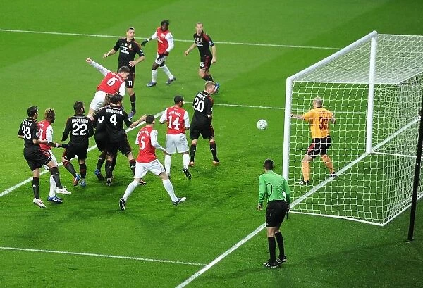 Koscielny's Header: Arsenal Takes the Lead Against AC Milan in Champions League