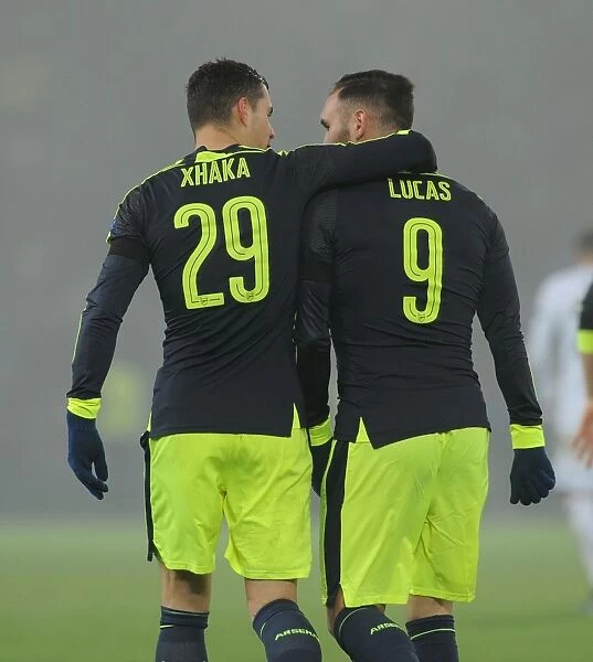 Lucas Perez and Granit Xhaka Celebrate Arsenal's Third Goal vs. FC Basel in 2016-17 UEFA Champions League