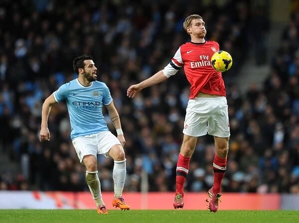 Per Mertesacker vs. Alvaro Negredo: Intense Battle at Manchester City vs. Arsenal (2013-14 Premier League)