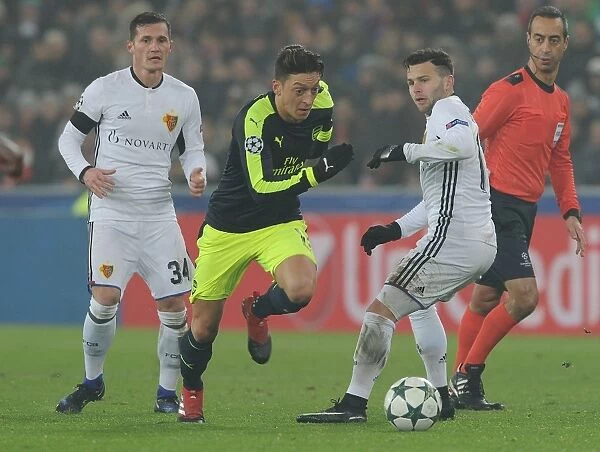Mesut Ozil Breaks Past Basel Defenders in Arsenal's UEFA Champions League Clash