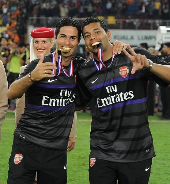 Mikel Arteta and Andre Santos Celebrate Arsenal's Victory over Malaysia XI