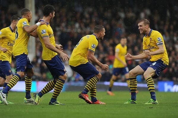 Podolski and Mertesacker Celebrate Arsenal's Winning Goals Against Fulham (2013-14)