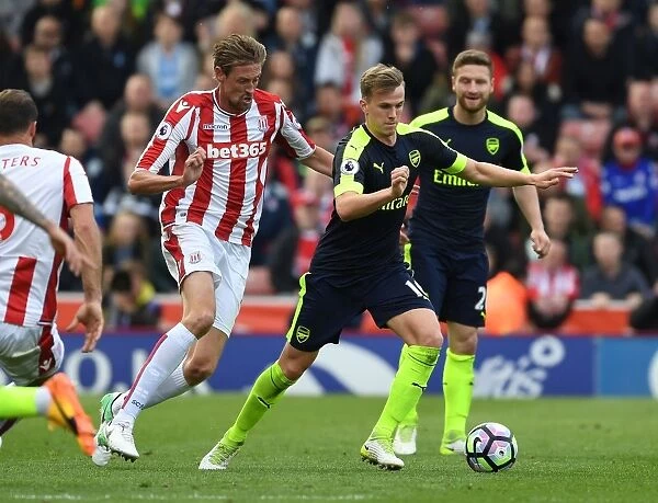 Rob Holding vs Peter Crouch: A Powerful Clash in the Premier League Battle between Stoke City and Arsenal (2016-17)
