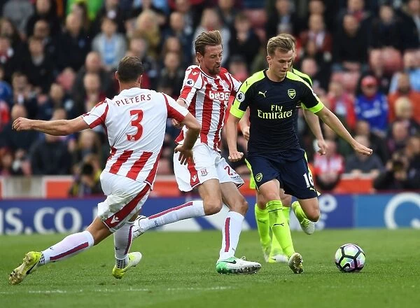 Rob Holding vs Peter Crouch: A Powerful Showdown in the Premier League Clash between Stoke City and Arsenal (2016-17)