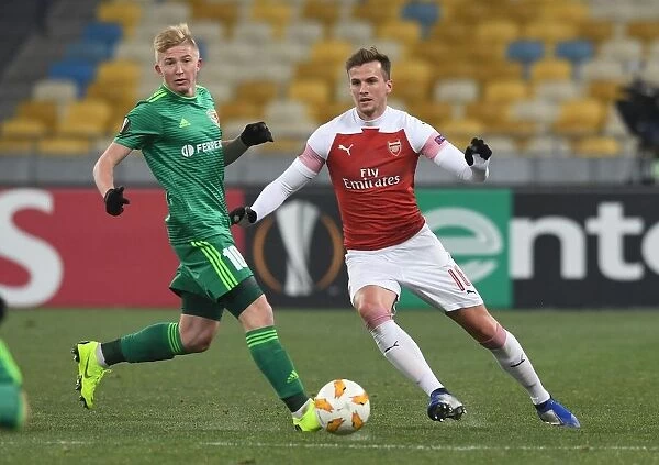 Rob Holding vs Vladyslav Kulach: Battle for Ball Possession in Arsenal's Europa League Clash with Vorskla Poltava
