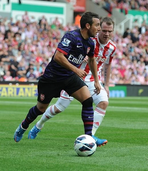 Santi Cazorla's Agile Outmaneuver of Glenn Whelan: A Iconic Moment from Arsenal's Victory over Stoke City (2012-13)