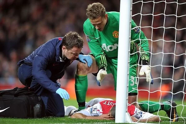 Theo Walcott Receives Treatment from Colin Lewin as Anders Lindegaard Looks On: Arsenal v Manchester United, Premier League 2011-12