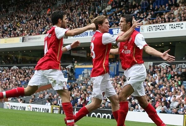 Van Persie's Euphoric Moment: Celebrating with Hleb and Fabregas against Blackburn Rovers