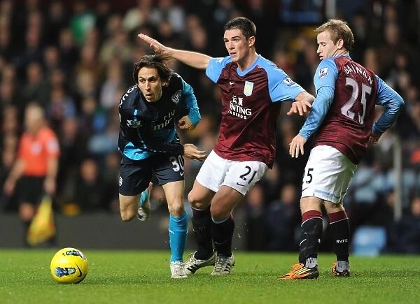 Yossi Benayoun Battles Past Barry Bannan and Ciaran Clark in Aston Villa vs Arsenal Premier League Clash