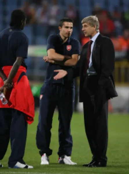 Buy Arsene Wenger the Arsenal Manager talks to Emmanuel Adebayor and Robin van Persie before the match.