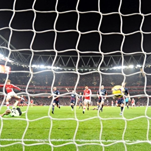 Andrey Arshavin shoots past Bolton goalkeeper Jussi Jskelainen to score the 4th Arsenal goal