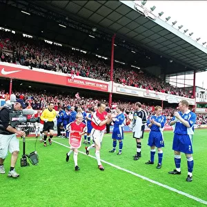 Arsenal captain Lee Dixon leads the team out onto the pitch for the match