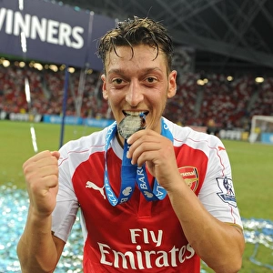 Arsenal Celebrate Asia Trophy Victory: Mesut Ozil Lifts the Trophy (2015)