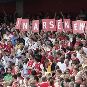 Arsenal fans hold up a sign in support of Arsene Wenger