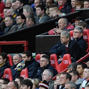 Arsenal Manager Arsene Wenger and his Assistant Pat Rice sit on the bench