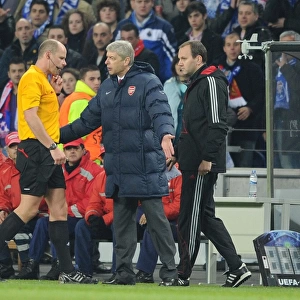 Arsenal manager Arsene Wenger talks to referee Martin Hansson after the 2nd Porto goal