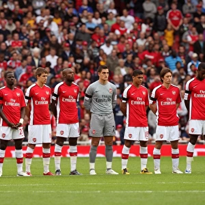 The Arsenal players line up for a minutes applause