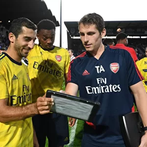 Arsenal Players Mkhitaryan and Willock Analyze Match Stats with Sports Scientist Allen