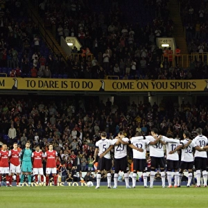 Arsenal and Tottenham players observe a minutes applause for Tottenham player Bobby Smith