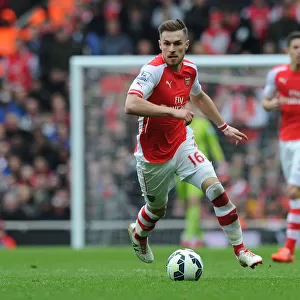 Arsenal vs. Liverpool: Aaron Ramsey's Intense Action in the 2014-15 Premier League Clash at Emirates Stadium