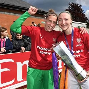 Arsenal Women Celebrate Historic WSL Title Win with Captains Sari van Veenendaal and Louise Quinn Holding the Trophy