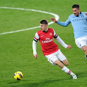 Arsenal's Aaron Ramsey Fends Off Manchester City's Javi Garcia in Intense Premier League Clash