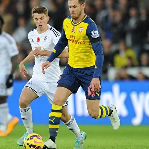 Arsenal's Aaron Ramsey Outmaneuvers Swansea's Tom Carroll