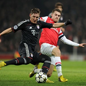 Arsenal's Aaron Ramsey Tackles Bastian Schweinsteiger in Intense Arsenal v Bayern Munich UCL Clash