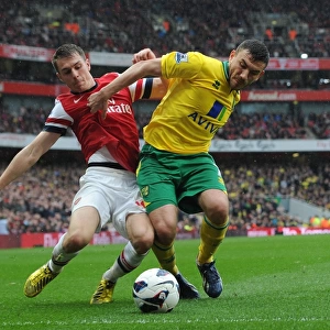 Arsenal's Aaron Ramsey Tackles Norwich's Robert Snodgrass in Premier League Clash
