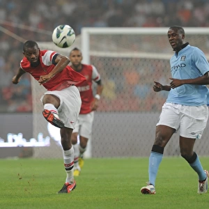 Arsenal's Abou Diaby Battles Past Yaya Toure in Arsenal FC vs Manchester City Pre-Season Clash in Beijing, 2012