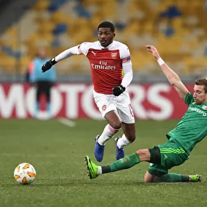 Arsenal's Ainsley Maitland-Niles Faces Off Against Vorskla Poltava's Lurii Kolomoets in Europa League Clash