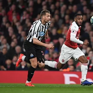 Arsenal's Alex Lacazette Faces Off Against Newcastle's Florian Lejeune in Premier League Clash