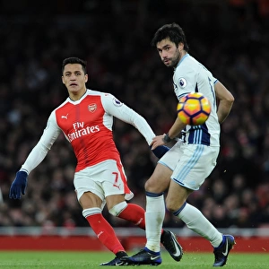 Arsenal's Alexis Sanchez Fends Off West Brom's Claudio Yacob