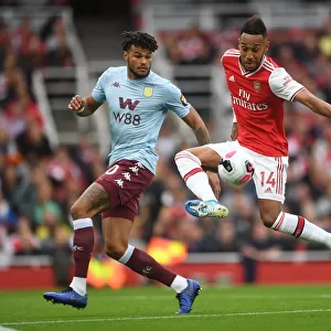 Arsenal's Aubameyang Faces Off Against Villa's Mings in Intense Premier League Clash