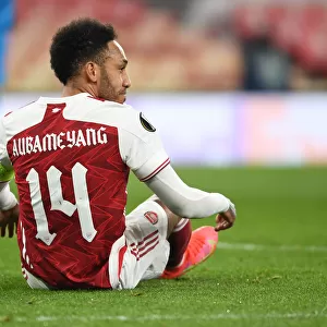 Arsenal's Aubameyang Fights for Europa League Victory Amidst Emirates Stadium's Empty Seats: Arsenal vs. Olympiacos Amidst Pandemic Restrictions
