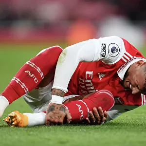 Arsenal's Ben White Clutches Injured Ankle Amidst Intense Arsenal v Chelsea Rivalry (2022-23)