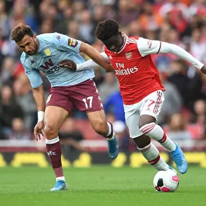 Arsenal's Bukayo Saka Clashes with Aston Villa's Trezeguet in Premier League Showdown