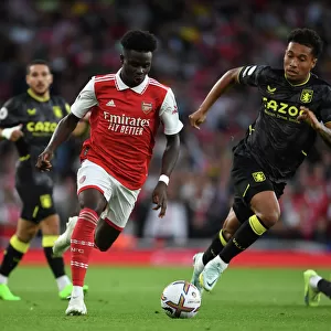 Arsenal's Bukayo Saka Clashes with Aston Villa's Jacob Ramsey in 2022-23 Premier League Showdown