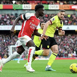 Arsenal's Bukayo Saka Evades Burnley's Charlie Taylor: Premier League Showdown at Emirates Stadium (2023-24)