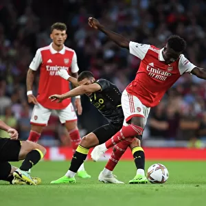 Arsenal's Bukayo Saka Outmaneuvers Aston Villa's Emiliano Buendia in Premier League Clash
