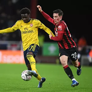 Arsenal's Bukayo Saka Outmaneuvers Harry Wilson in FA Cup Clash