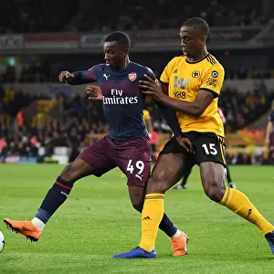 Arsenal's Eddie Nketiah Battles Willy Boly in Intense Wolverhampton Wanderers Clash