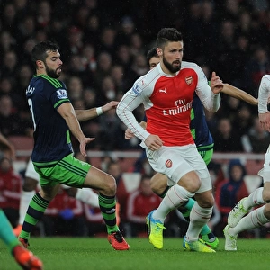 Arsenal's Giroud and Ramsey Outmaneuver Swansea's Amat during Intense Premier League Showdown