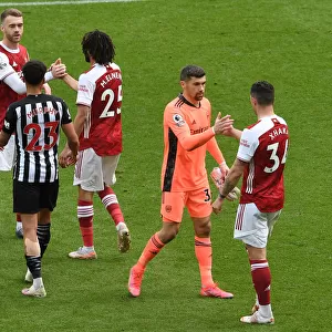 Arsenal's Granit Xhaka Celebrates with Mat Ryan after Newcastle United Win: 2020-21 Premier League Clash Amidst Empty St. James Park