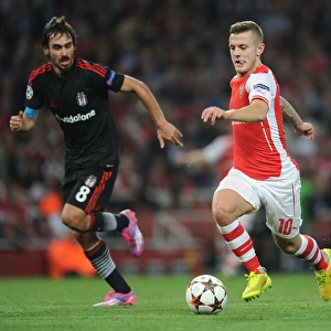 Arsenal's Jack Wilshere Clashes with Besiktas Veli Kavlak in UEFA Champions League Qualifier