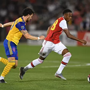 Arsenal's Joe Willock Clashes with Colorado Rapids Jordan Schweitzer in 2019 Pre-Season Match