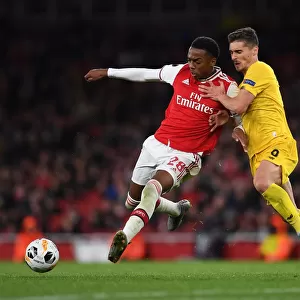 Arsenal's Joe Willock Clashes with Standard Liege's Gojko Cimirot in Europa League Match