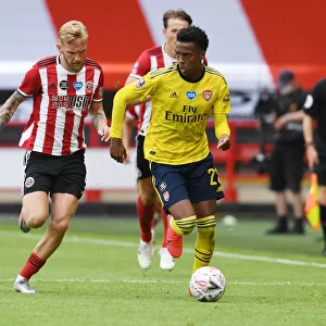 Arsenal's Joe Willock Outmaneuvers Sheffield United's Olivier McBurnie in FA Cup Quarterfinal