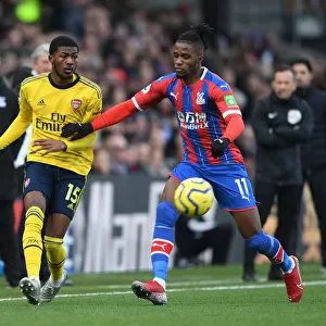 Arsenal's Maitland-Niles Faces Pressure from Zaha in Crystal Palace Clash (Premier League 2019-20)